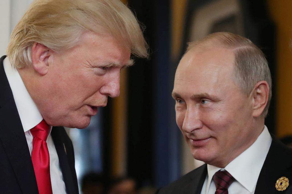 US President Donald Trump chatting with Russia's President Vladimir Putin at the APEC Economic Leaders' Meeting in Vietnam