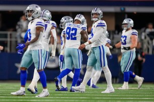  Cowboys quarterback Dak Prescott, second from right, heads to the bench after his pass was intercepted and returned for a touchdown by Green Bay Packers safety Darnell Savage 