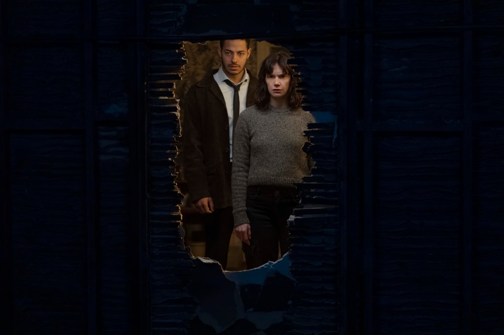 Detective Colman Akanda (Daryl McCormack) and Lorna's (Ruth Wilson) stand looking at the outline of a wall. 