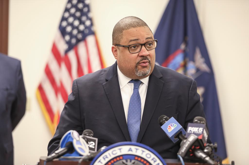 District Attorney Alvin Bragg speaks at a podium with microphones, speaking to press after the recovery of 2 Nazi-looted Egon Schiele paintings.