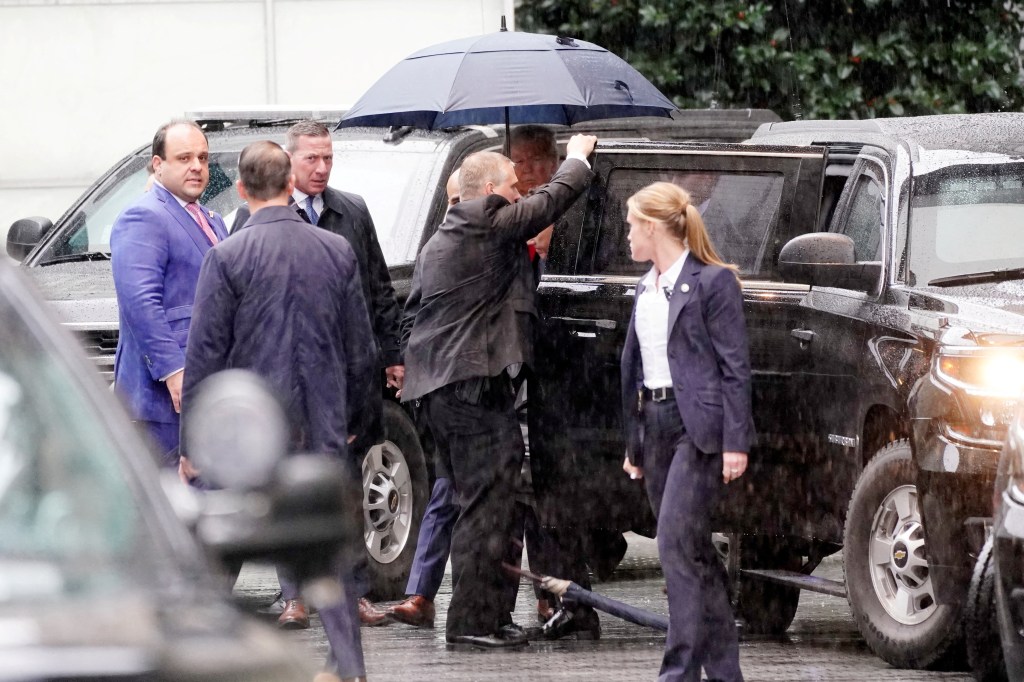 Former U.S. President Donald Trump was seen into a vehicle after a brief press conference at a hotel, following his hearing at District Court.
