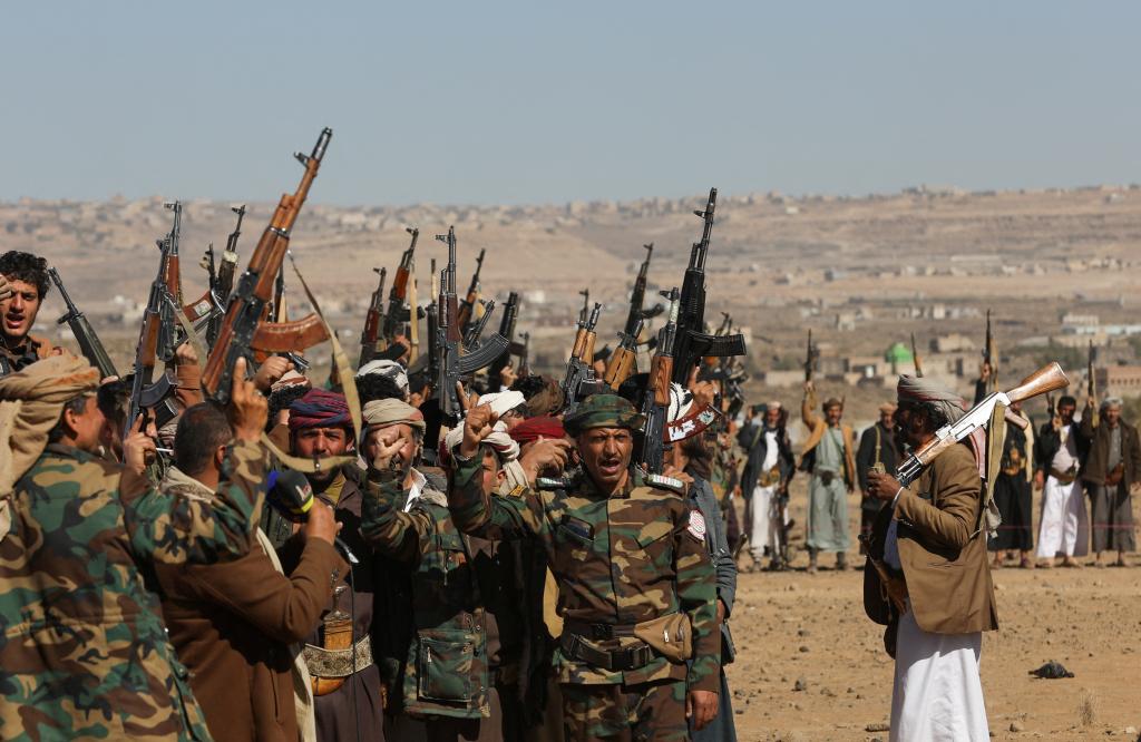 Houthi terrorists and tribal supporters hold up their firearms during a protest against recent US-led strikes on Houthi targets, near Sanaa, Yemen on January 14, 2024.