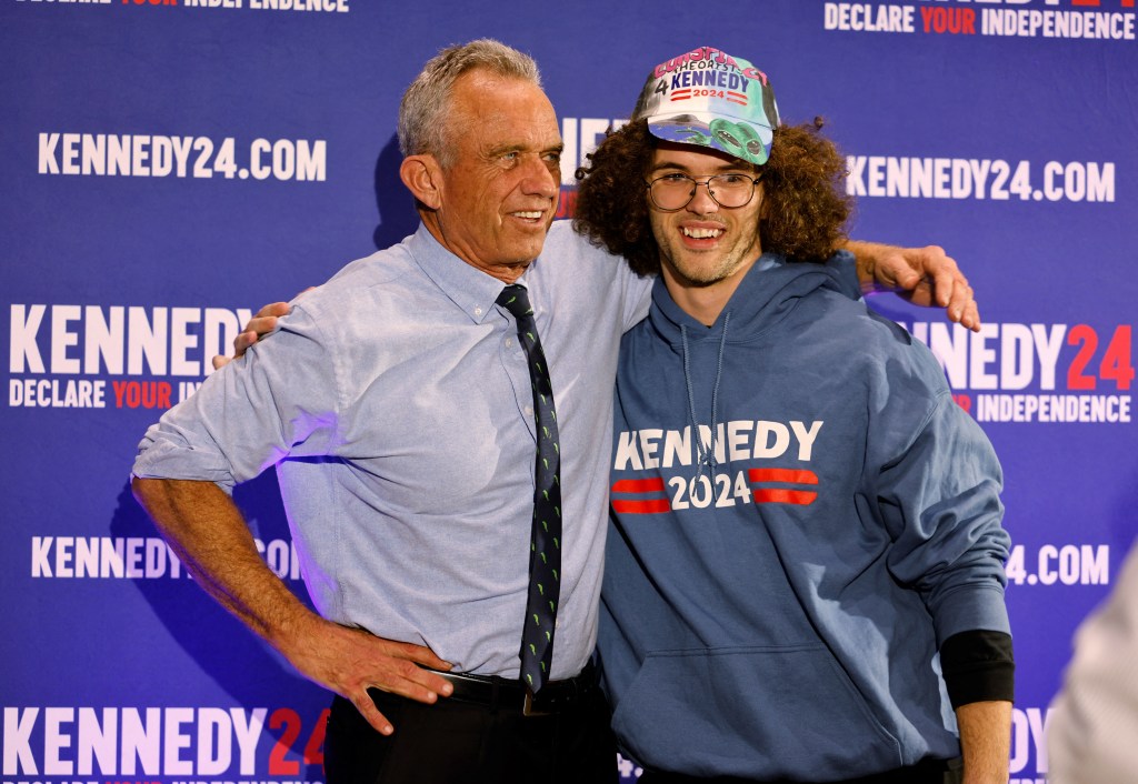 Robert Kennedy with his arm around young voter wearing a Kennedy 2024 shirt