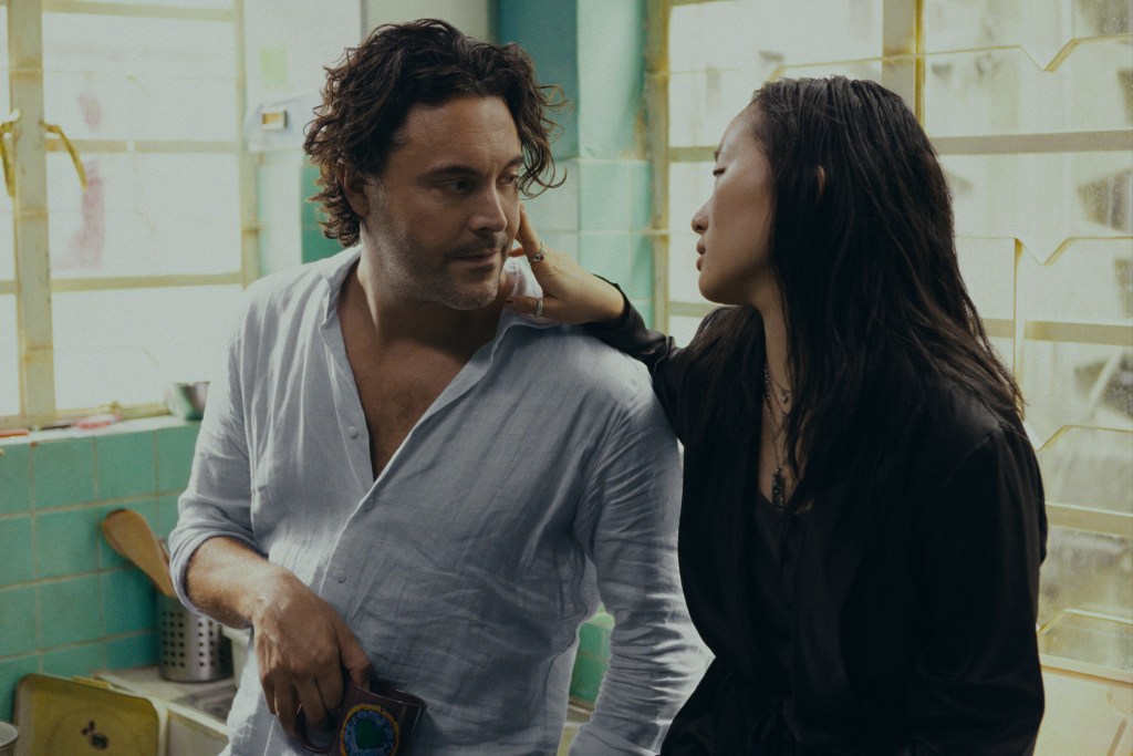 David (Jack Huston) and Mercy (Ji-young Yoo) in "Expats" looking at each other. 