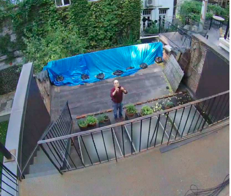 A surveillance camera image of Norman Resnicow near Theroux's rear terrace.