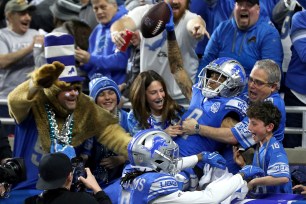 Josh Reynolds celebrates a touchdown with Lions fans during Sunday's divisional round game.