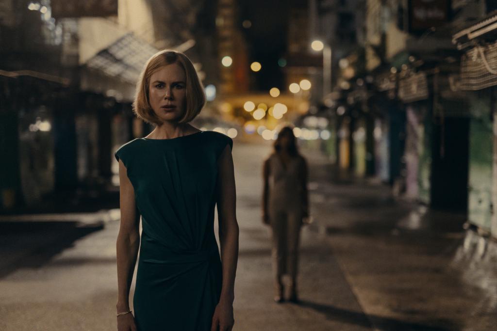 Nicole Kidman standing in the middle of an empty street. 