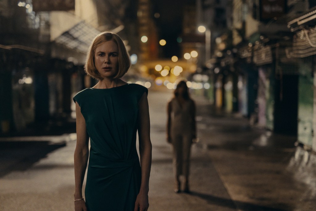 Nicole Kidman standing in the middle of an empty street. 