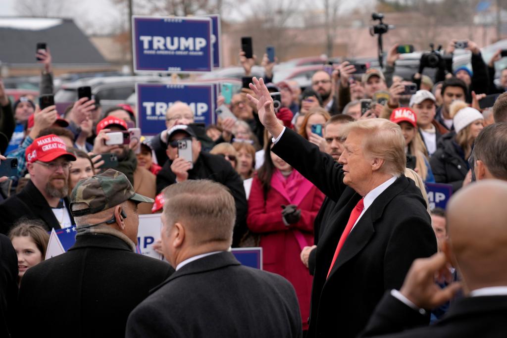 Republican presidential candidate former President Donald Trump waves to supporters as he arrives at a campaign stop in Londonderry, N.H., Tuesday, Jan. 23, 2024. 