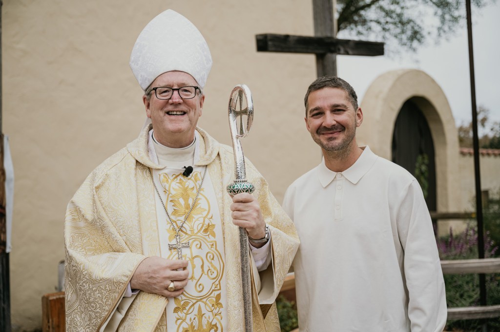 Shia LaBeouf stands with Bishop Robert Barron after making his confirmation.