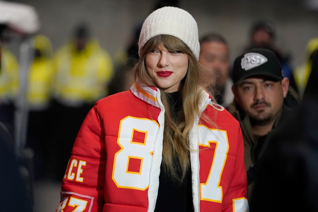 Taylor Swift wears a Kansas City Chiefs tight end Travis Kelce jacket by Kristin  Juszczyk before the Chiefs-Dolphins wild-card playoff football game on January 13, 2024, in Kansas City, Mo. 