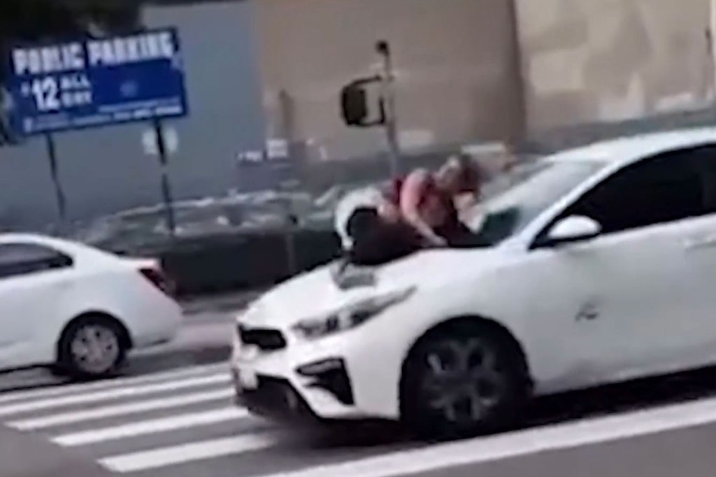 woman on car hood