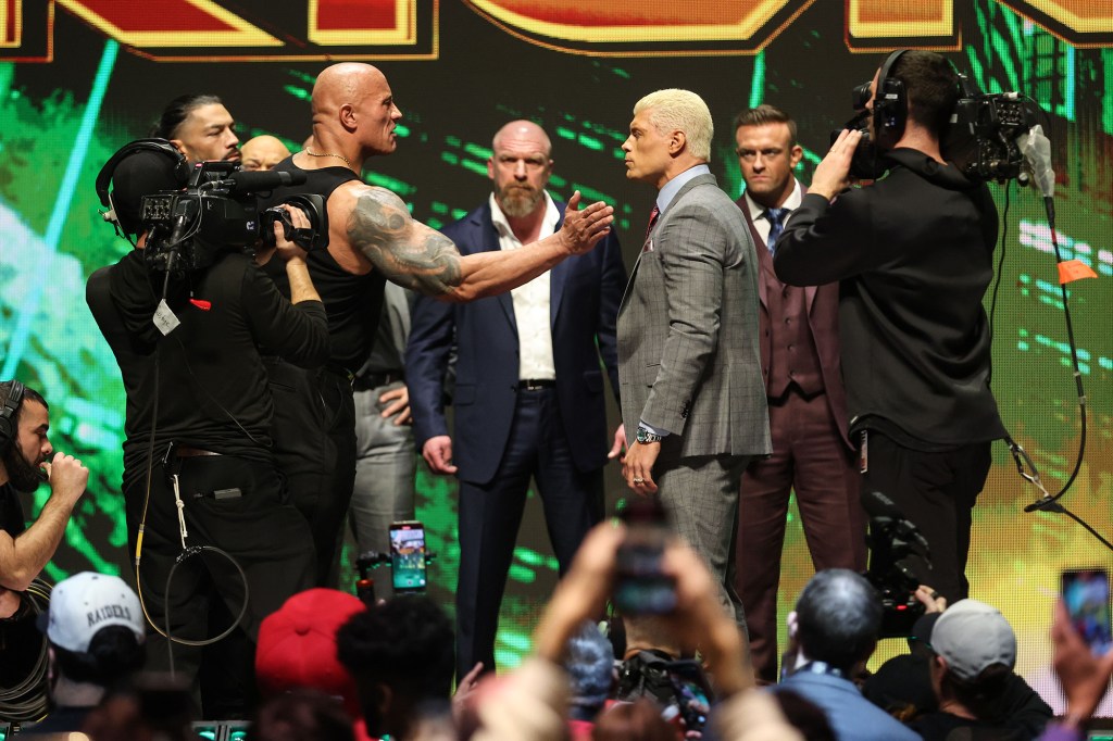 The Rock slaps Cody Rhodes during the WrestleMania kickoff event.