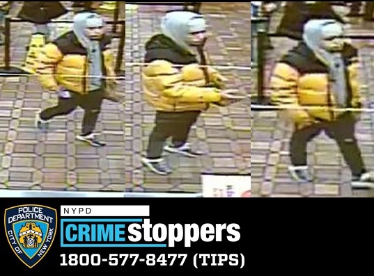 The suspect in a string of cell phone thefts, seen wearing a yellow and black winter coat.