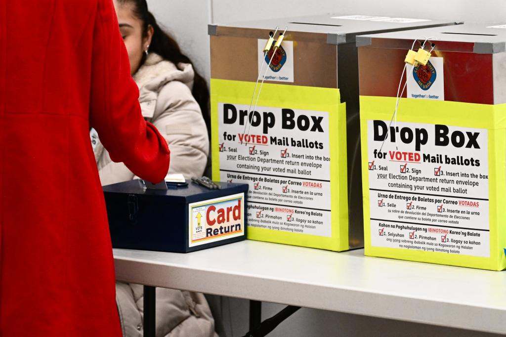 A pair of ballot drop boxes for voted mail ballots are displayed as a voter returns a voting card in a Clark County vote center on Election Day during the Nevada 2024 presidential primary election in Las Vegas, Nevada, on February 6, 2024. 