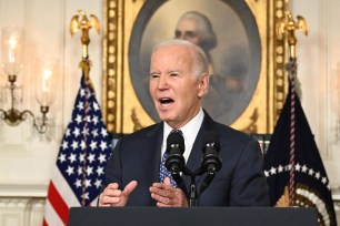 Joe Biden speaking into microphones about the Special Counsel report.