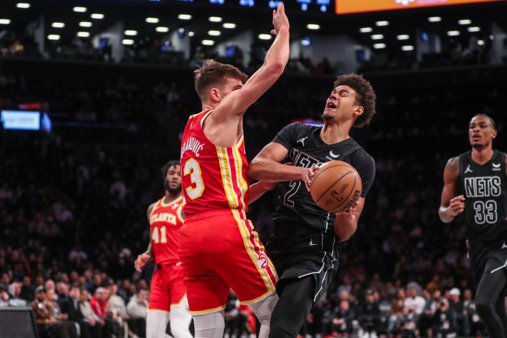 Cameron Johnson moves the ball against Atlanta Hawks guard Bogdan Bogdanovic (13) in the first quarter at Barclays Center.