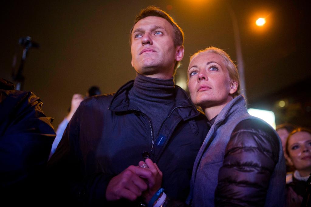 Russian opposition leader Alexei Navalny with his wife Yulia after his last rally in rain-soaked Moscow, Russia, on Sept. 6, 2013. 