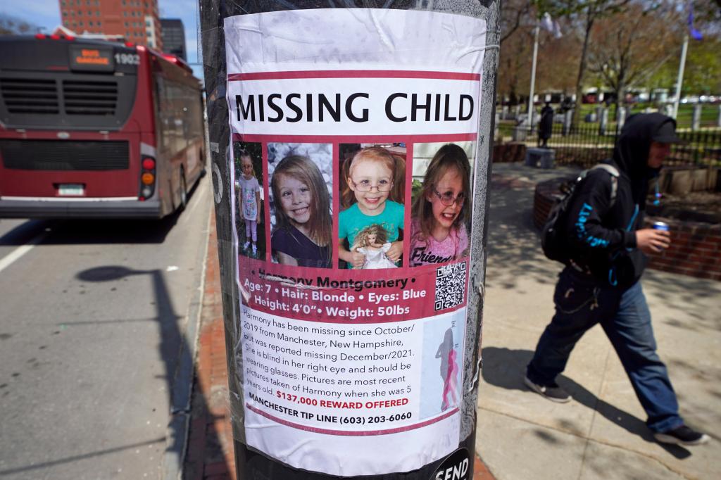 A man walks past a "missing child" poster for Harmony Montgomery