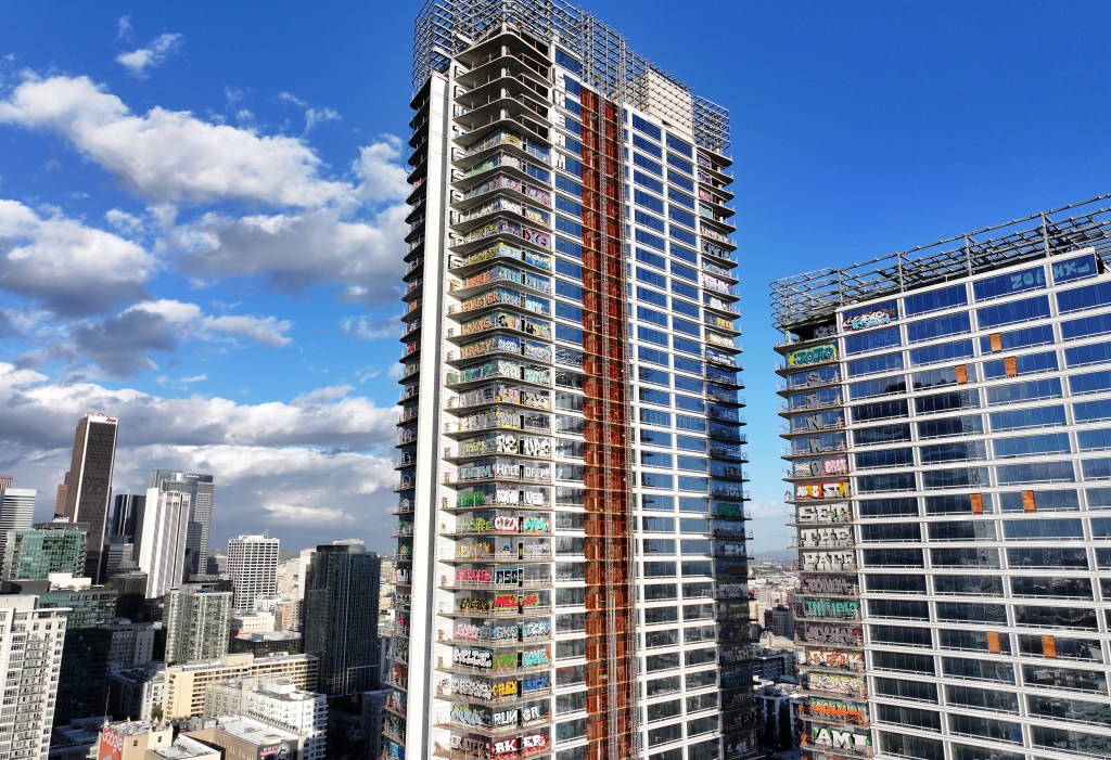 Unfinished skyscraper with graffiti on 27 floors in Los Angeles, California. The building has many windows and is located downtown.