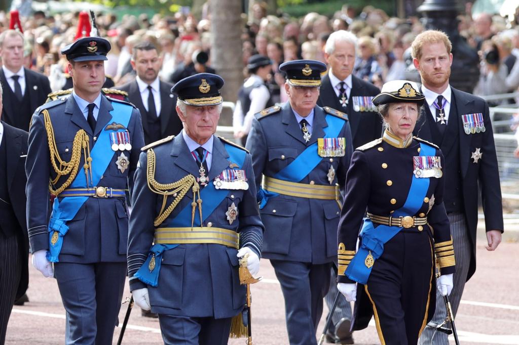 Coffin procession of Queen Elizabeth II with military personnel walking behind in London, England.