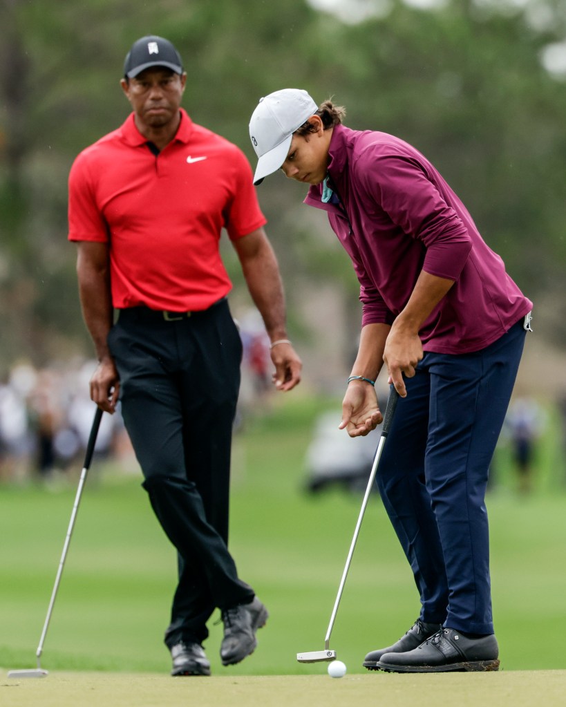 Tiger Woods, left, watches his son Charlie, right, putt ball during the final round of the PNC Championship golf tournament Sunday, Dec. 17, 2023, in Orlando, Fla. 