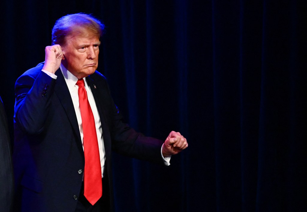 Former US President and 2024 presidential hopeful Donald Trump gestures during a Caucus Night watch party in Las Vegas, Nevada, on February 8, 2024. 