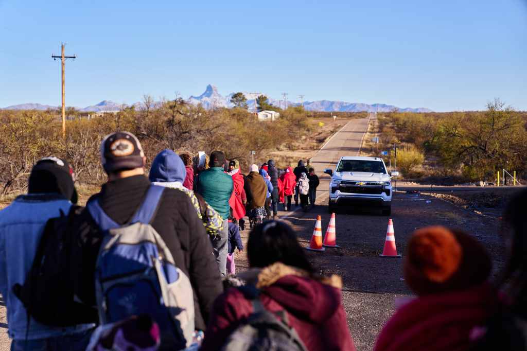 Migrants waiting to be processed at a Customs and Border Protection station near the border in Sasabe, Arizona on Feb. 11, 2024.