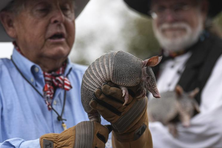 Ralph Fisher holds up Bobby, the three-month-old armadillo