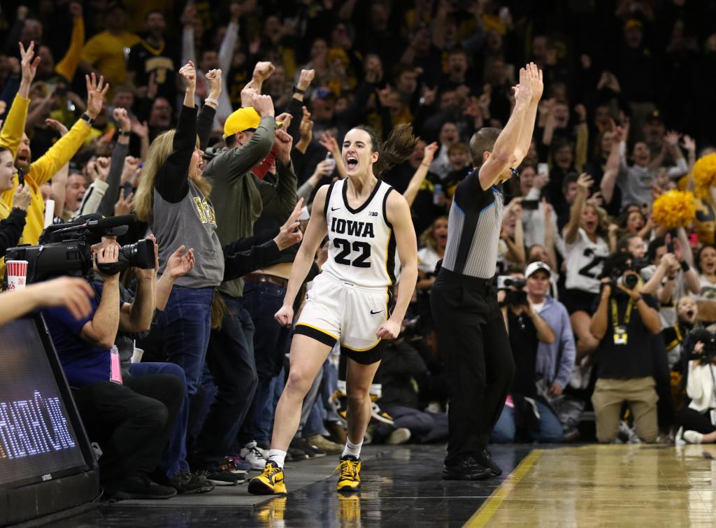 aitlin Clark #22 of the Iowa Hawkeyes celebrates after breaking the NCAA women's all-time scoring record 