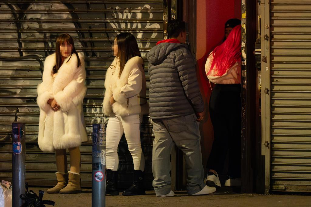 A potential customer is led inside a brothel on Roosevelt Avenue