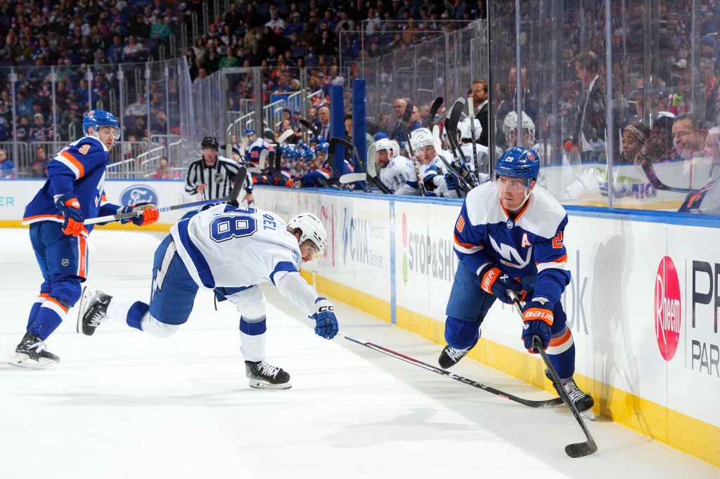 Brock Nelson #29 of the New York Islanders is defended by Brandon Hagel #38 of the Tampa Bay Lightning during the first period.