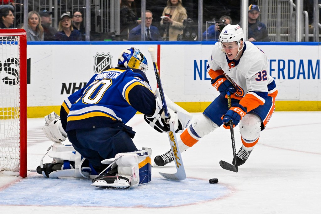 Islanders center Kyle Maclean controls the puck as St. Louis Blues goaltender Jordan Binnington (50) defends the net during the third period.