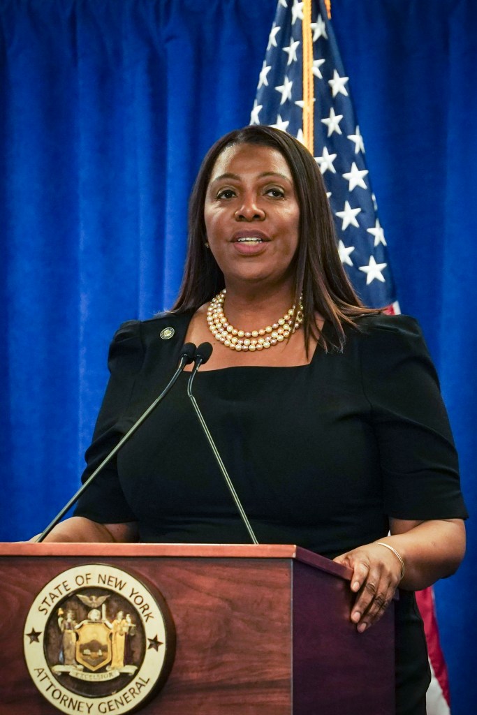 New York Attorney General Letitia James standing at a podium with a flag behind her during a press briefing in New York.