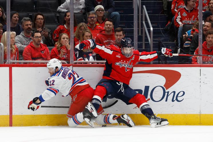 Tom Wilson (43) of Washington Capitals checks Jonny Brodzinski (22) of New York Rangers during NHL game at Capital One Arena.