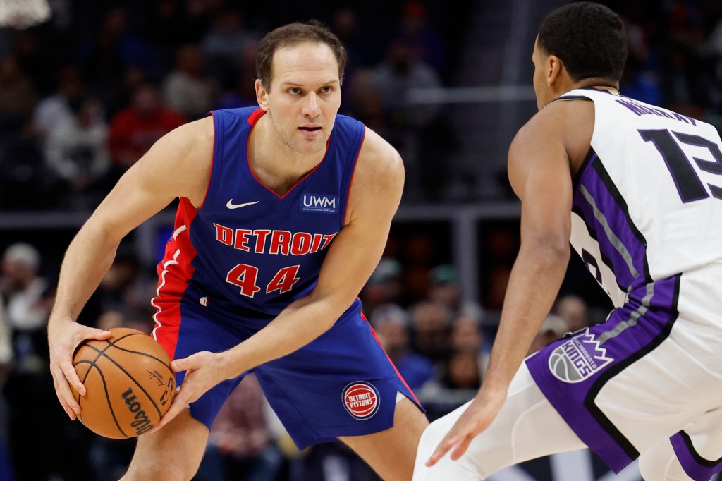 Bojan Bogdanovic (44) is defended by Keegan Murray (13) in a basketball game between Detroit Pistons and Sacramento Kings at Little Caesars Arena.