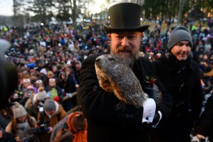 Groundhog handler AJ Derume holds Punxsutawney Phil, who saw his shadow, predicting a late spring during the 136th annual Groundhog Day festivities