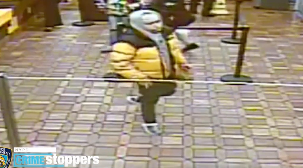 The suspect in a string of cell phone thefts, seen wearing a yellow and black winter coat.