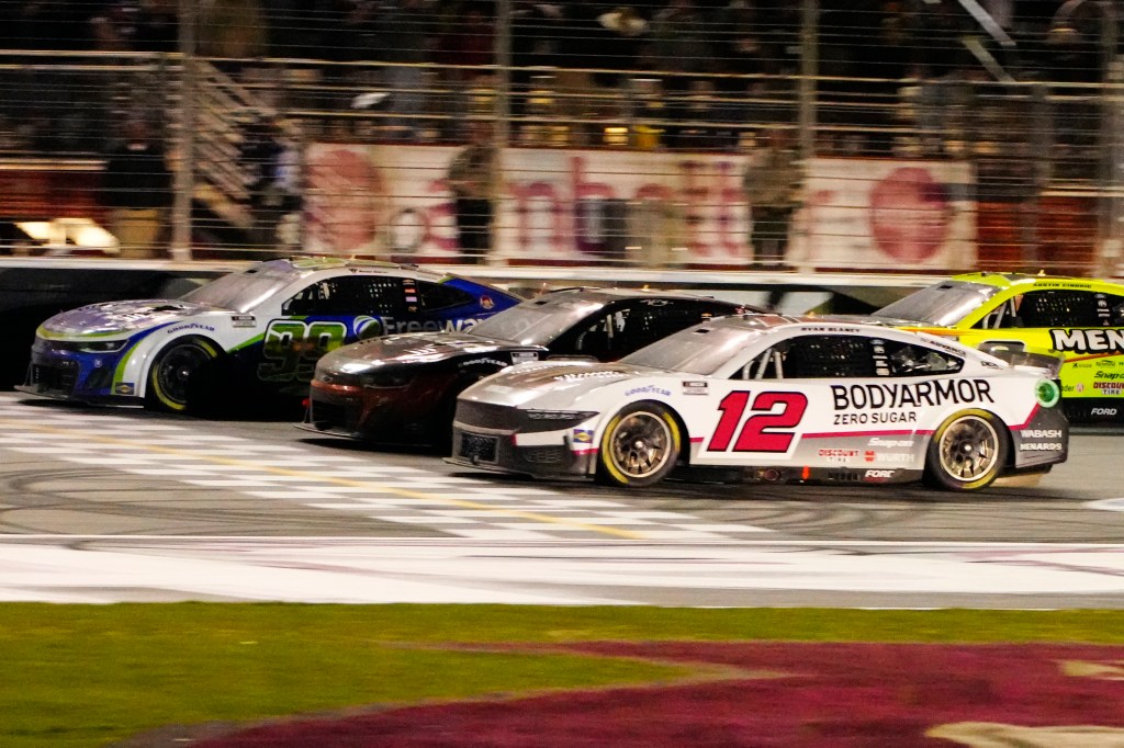 Daniel Suarez (99), left, edges out Kyle Busch (8), center, and Ryan Blaney (12) at the finish line to win during the NASCAR auto race at Atlanta Motor Speedway on Feb. 25, 2024.