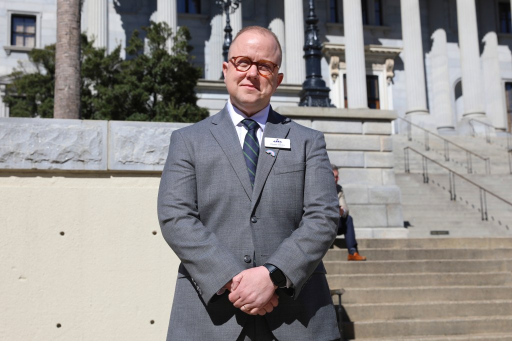 Chase Glenn outside the South Carolina statehouse participating in a rally against gender-affirming care ban for minors.