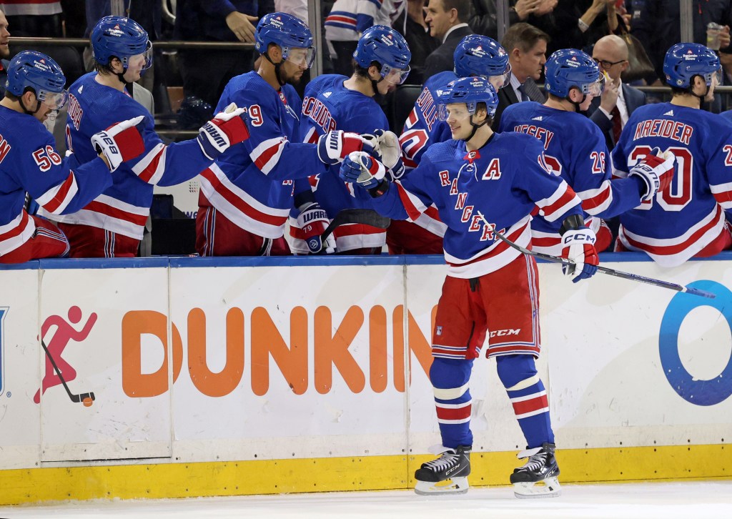 Artemi Panarin celebrates with teammates after scoring the first of his two goals in the Rangers' win.