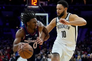Ben Simmons, who had five assists and nine rebounds, defends Tyrese Maxey during the Nets' loss.