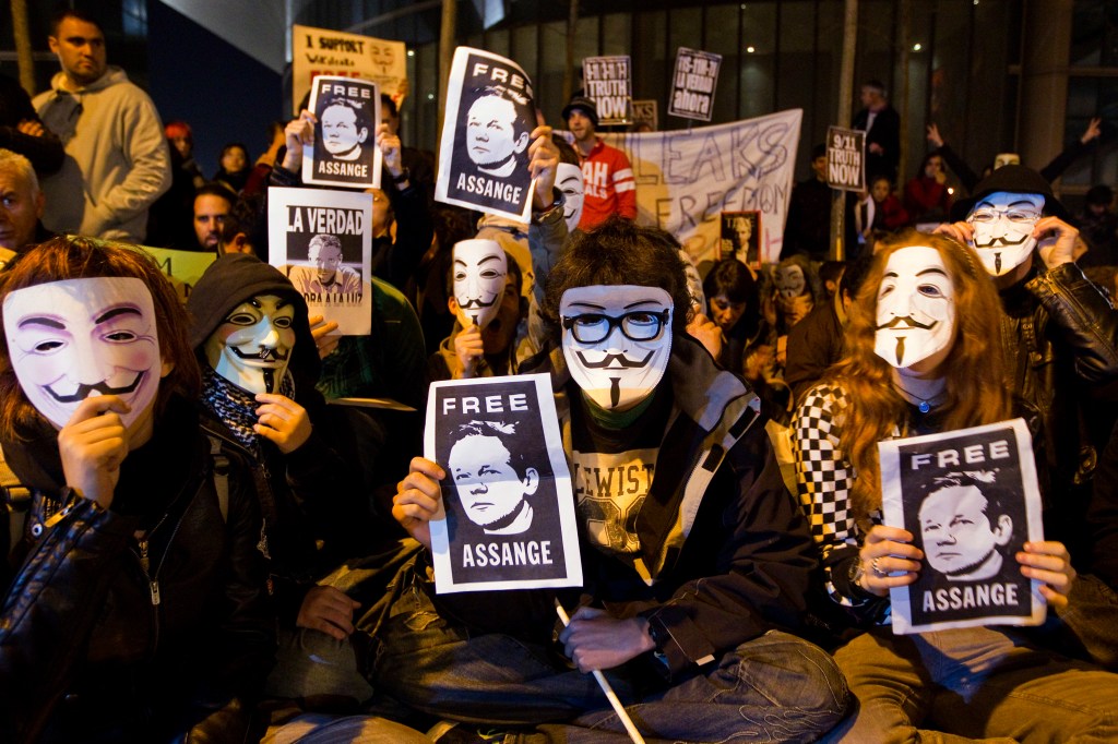 Supporters of WikiLeaks founder Julian Assange hold posters with his photo during a protest in front of the British Embassy in Madrid, Spain, on Dec. 11, 2010. 