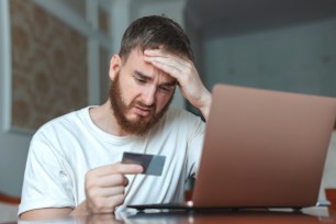 A man frustrated by his credit card debt.