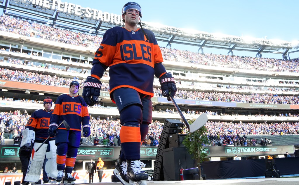 Cal Clutterbuck, whose career could be over in a couple of months, takes the ice before the Islanders' OT loss to the Rangers in the Stadium Series.