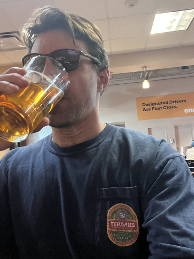 Barstool's Donnie sips a beer in the airport after helping to subdue a man who was trying to open the emergency exit door on a flight.