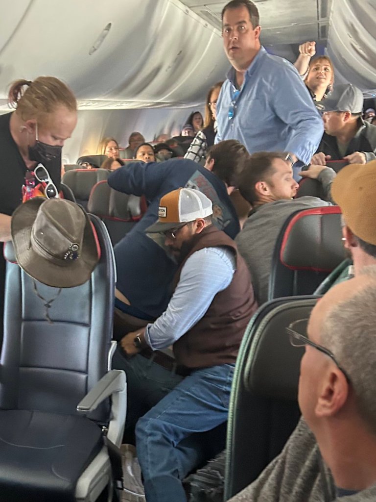 Barstool personality Donnie Does World and several others help subdue a man who tried to open the emergency exit door ona. flight.