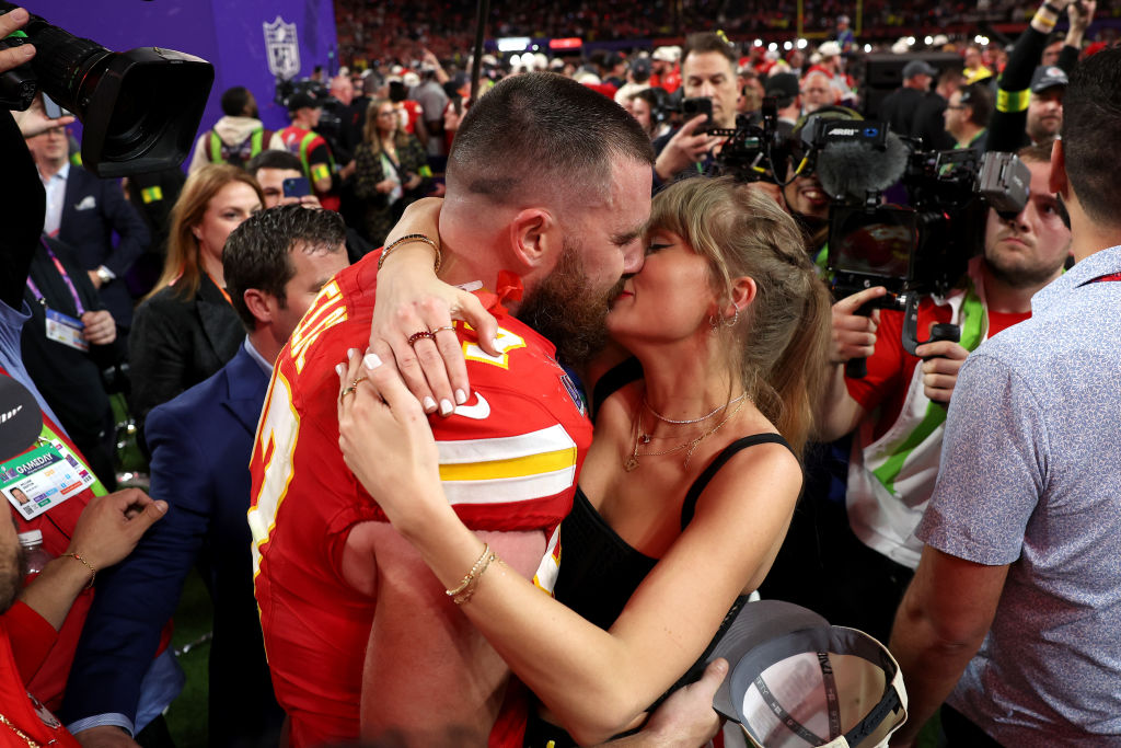 Taylor Swift and Travis Kelce kiss after the Chiefs won Super Bowl 2024 in Las Vegas.