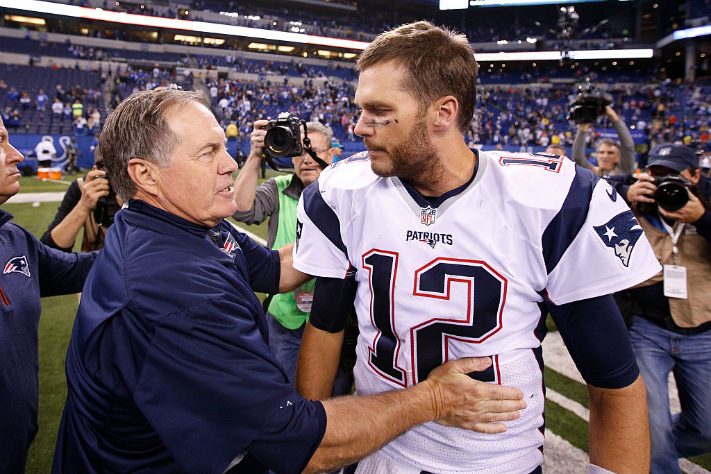 Head coach Bill Belichick and Tom Brady #12 of the New England Patriots congratulate each other after the game against the Indianapolis Colts at Lucas Oil Stadium on October 18, 2015 in Indianapolis, Indiana. The Patriots defeated the Colts 34-27.