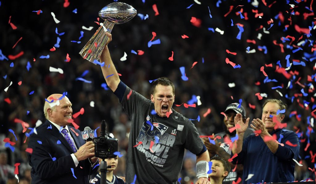 Tom Brady #12 of the New England Patriots holds the Vince Lombardi Trophy as Head coach Bill Belichick (R) looks on after defeating the Atlanta Falcons 34-28 in overtime during Super Bowl 51 at NRG Stadium on February 5, 2017 in Houston, Texas.
